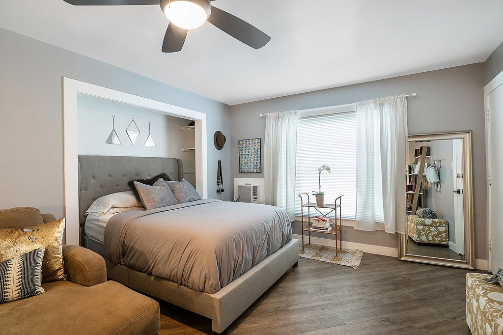 a bedroom with a large bed and a ceiling fan