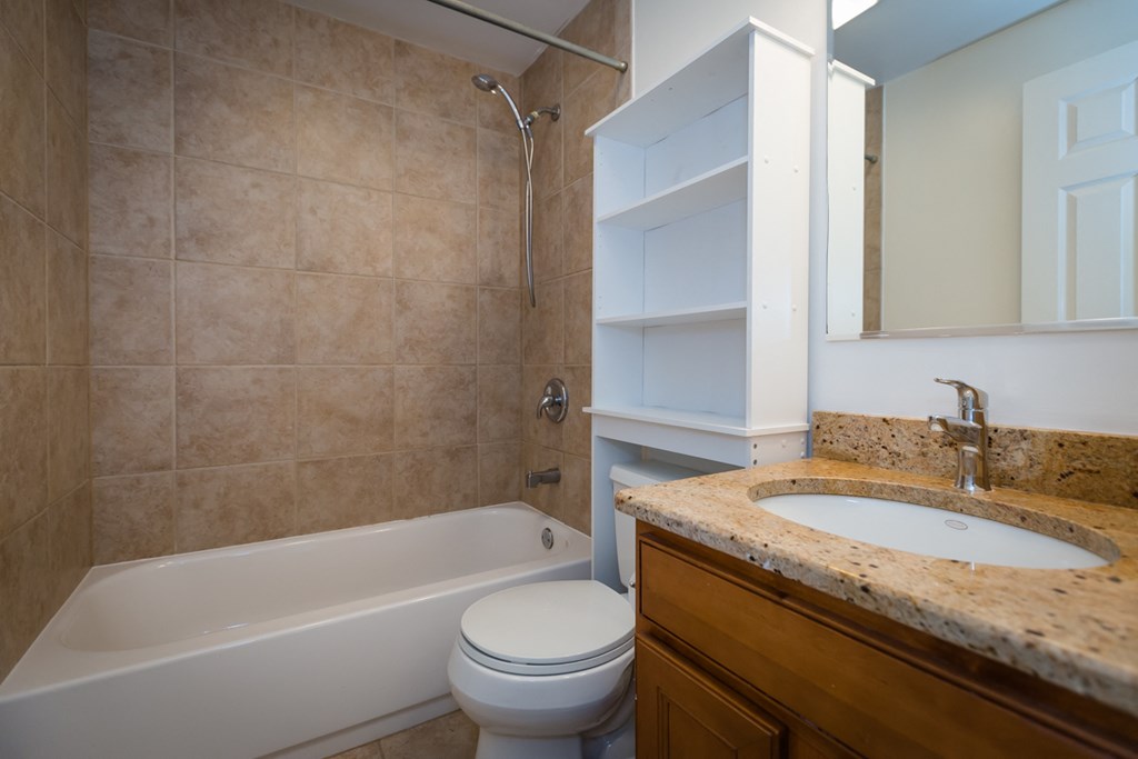 a bathroom with a sink toilet and a tub