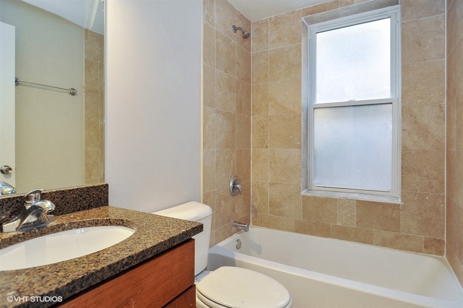 a bathroom with a sink toilet and a tub