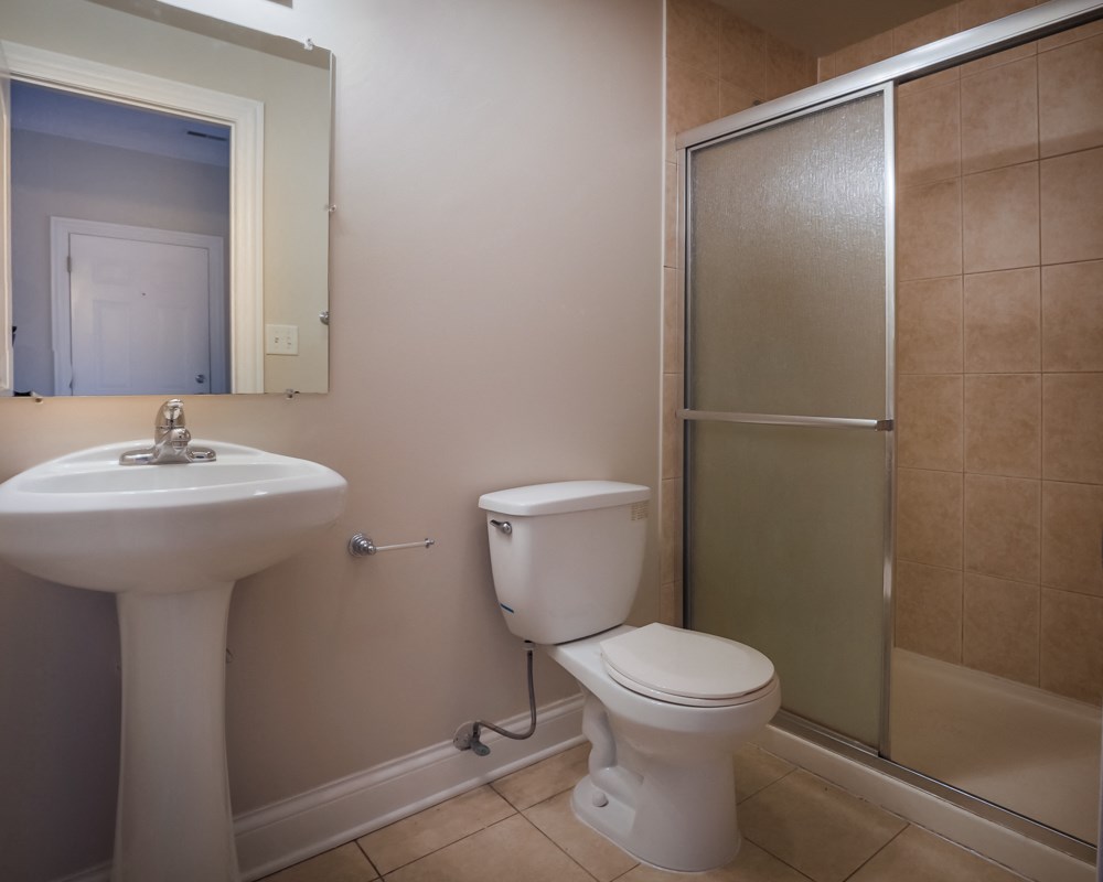 a bathroom with a toilet and a sink and a shower