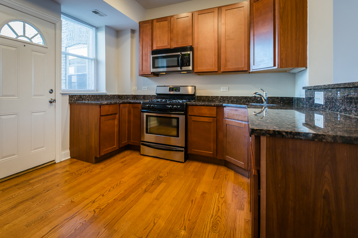 a kitchen with wooden cabinets and stainless steel appliances