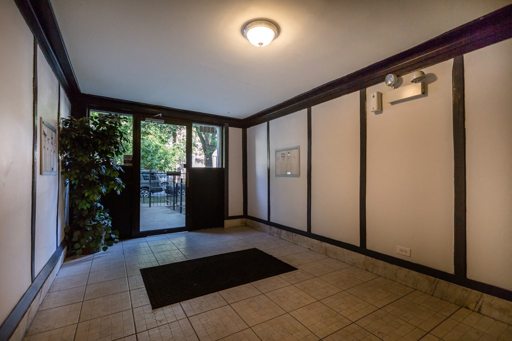 an empty room with white walls and a sliding glass door