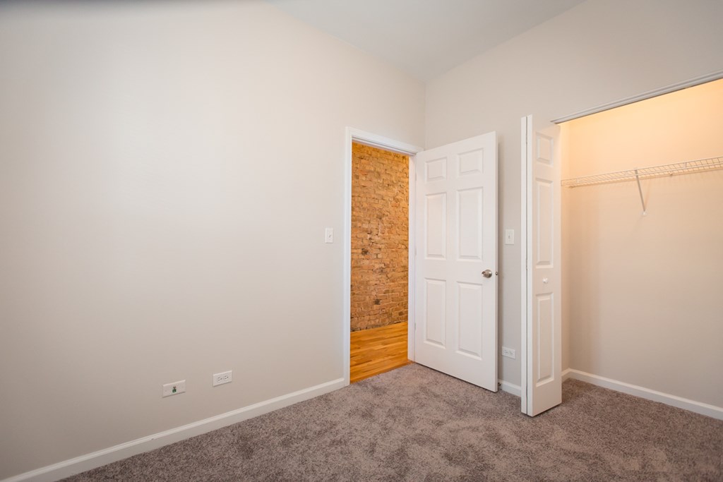 a bedroom with a closet and a door to a closet