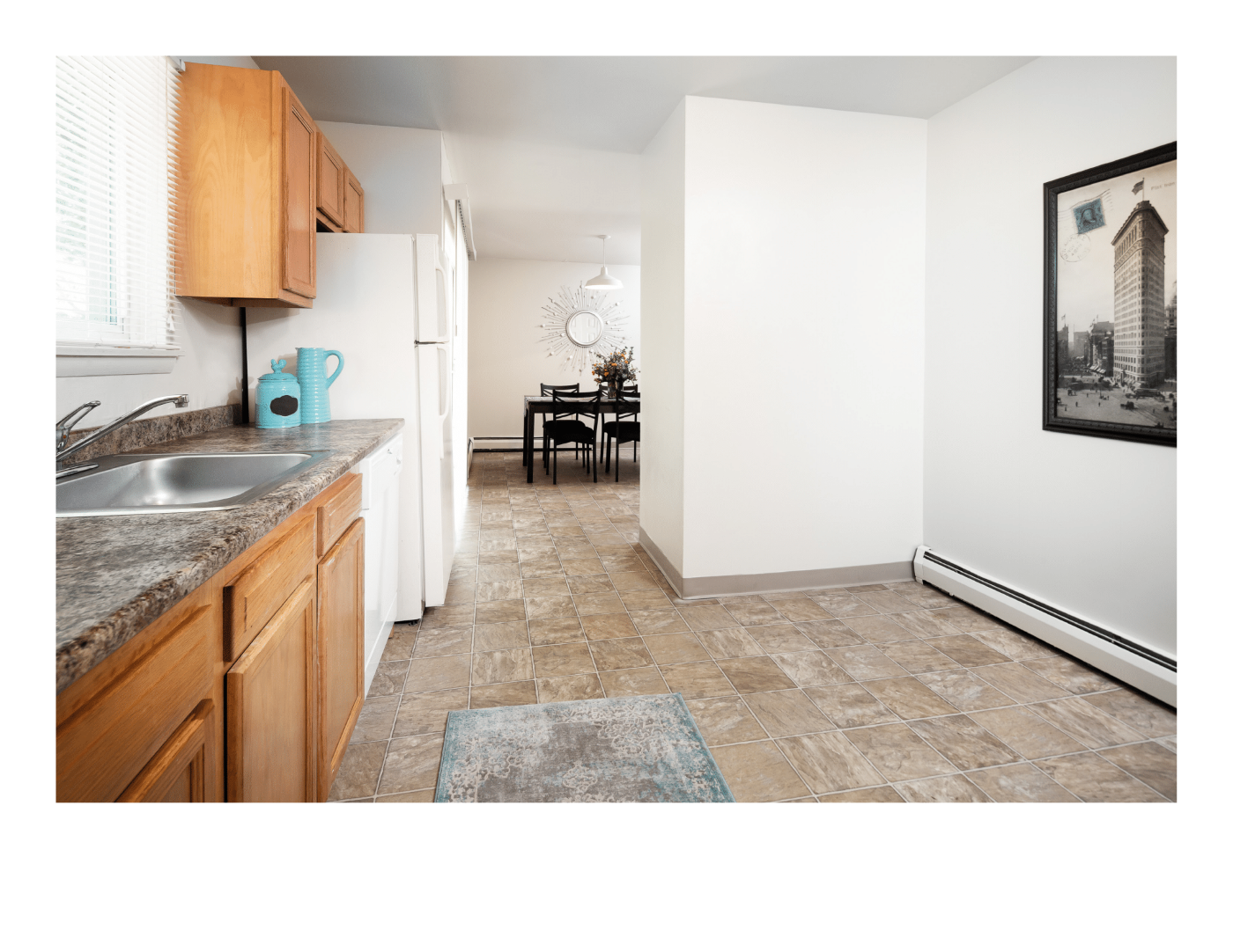 A kitchen with a table and chairs in the middle of the room.