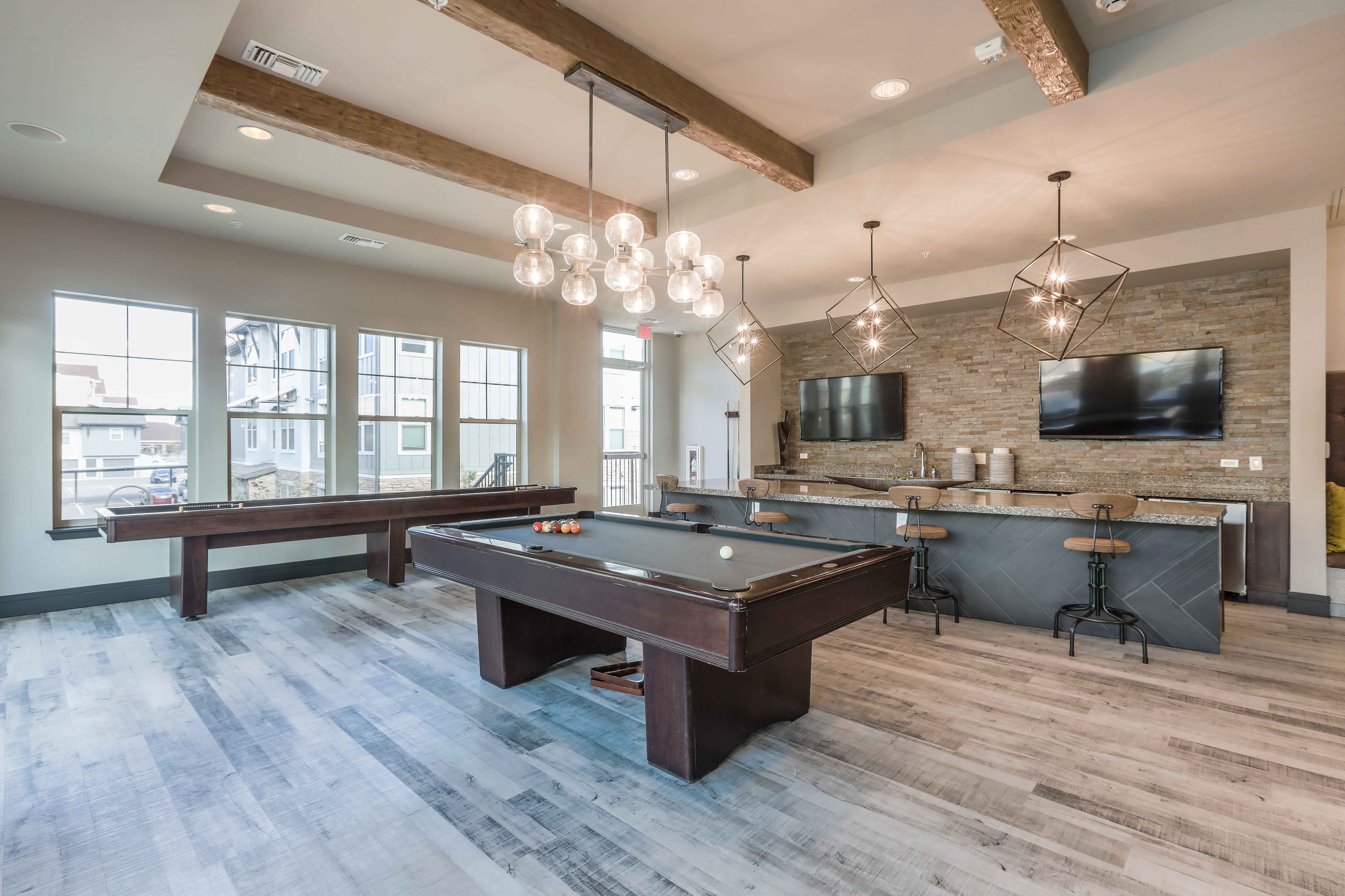 a game room with a pool table and a tv