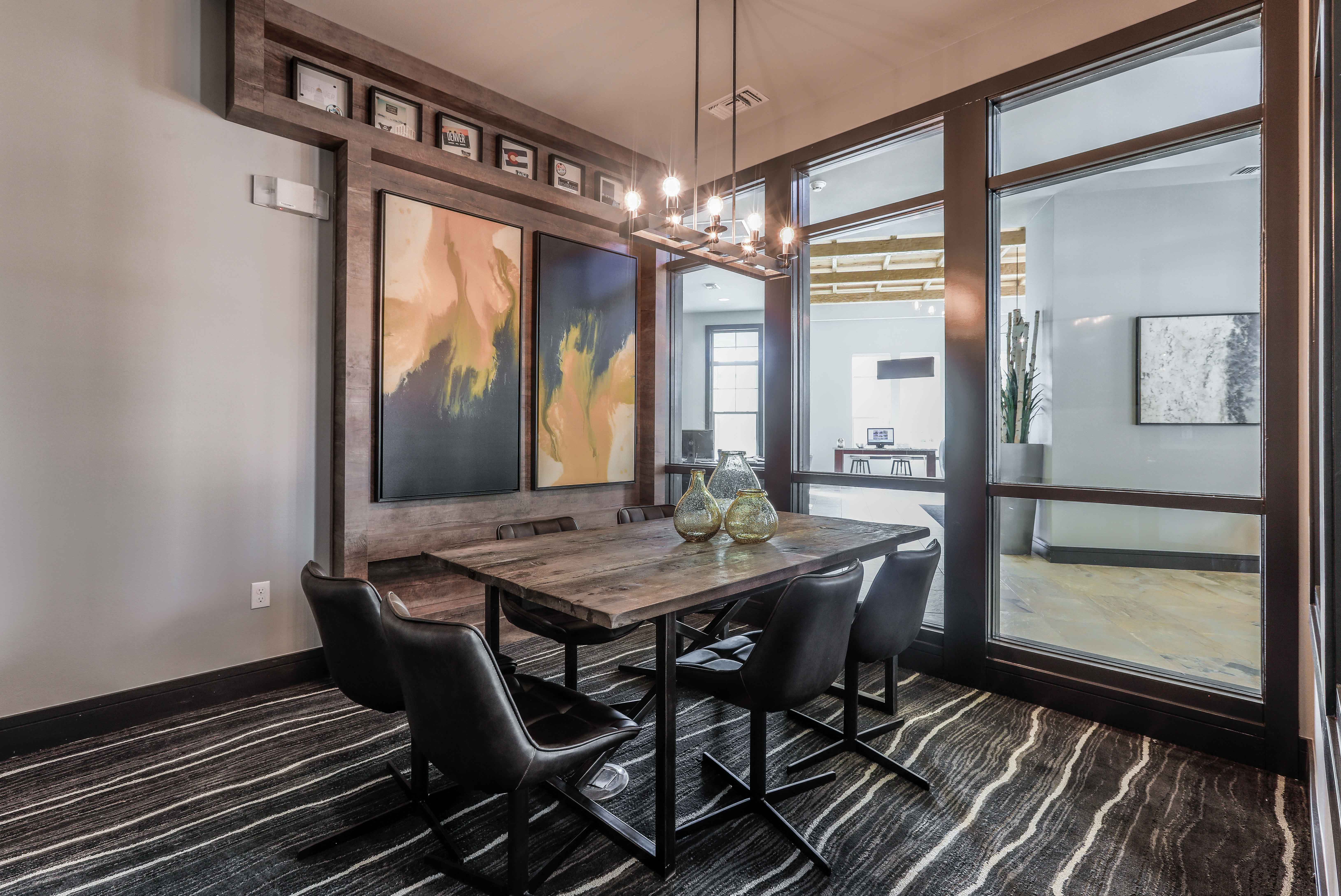 a dining room with a wooden table and chairs