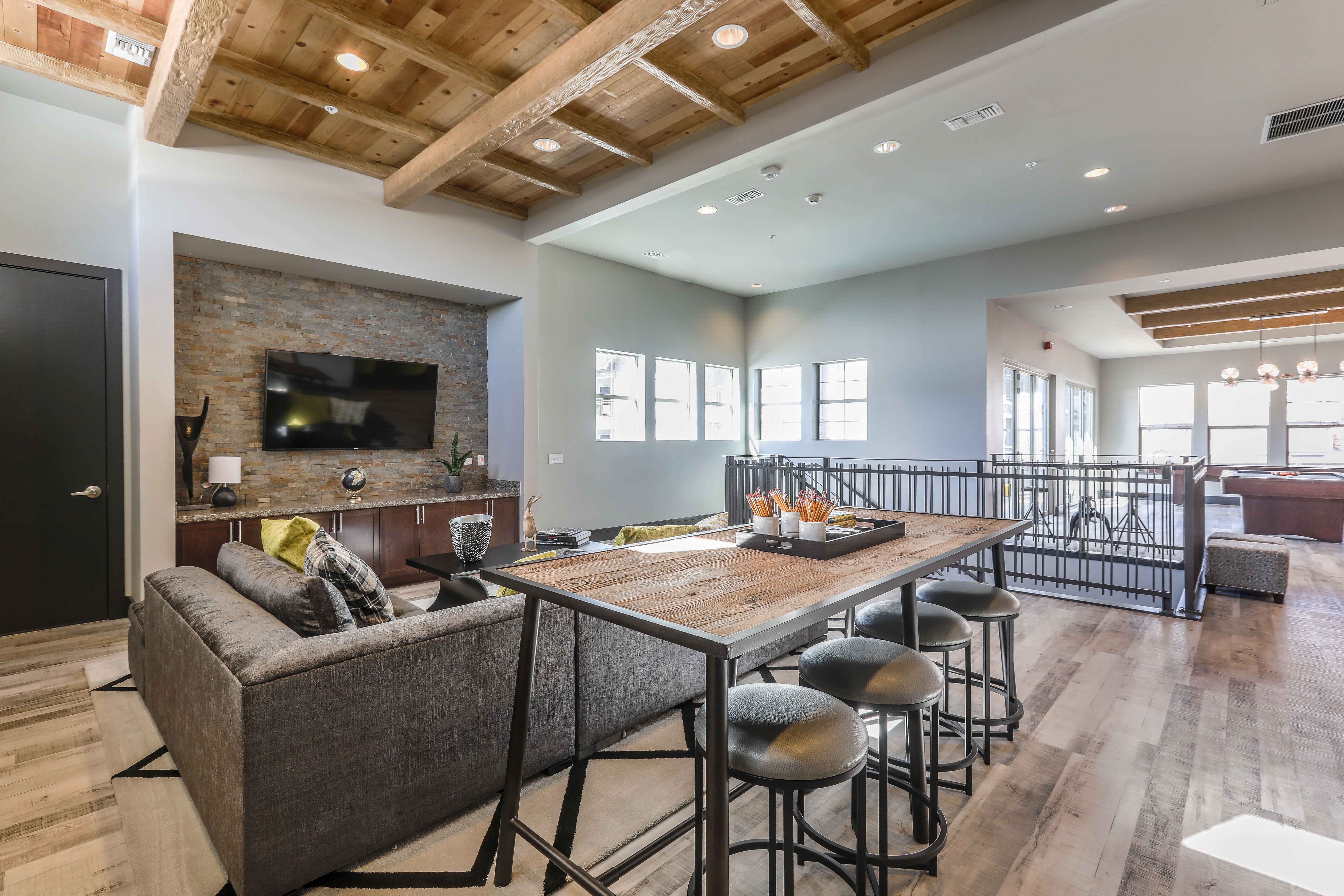 a living room with a dining room table and a television