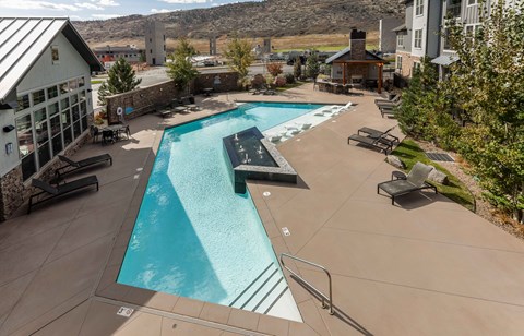 A large outdoor swimming pool with a slide.