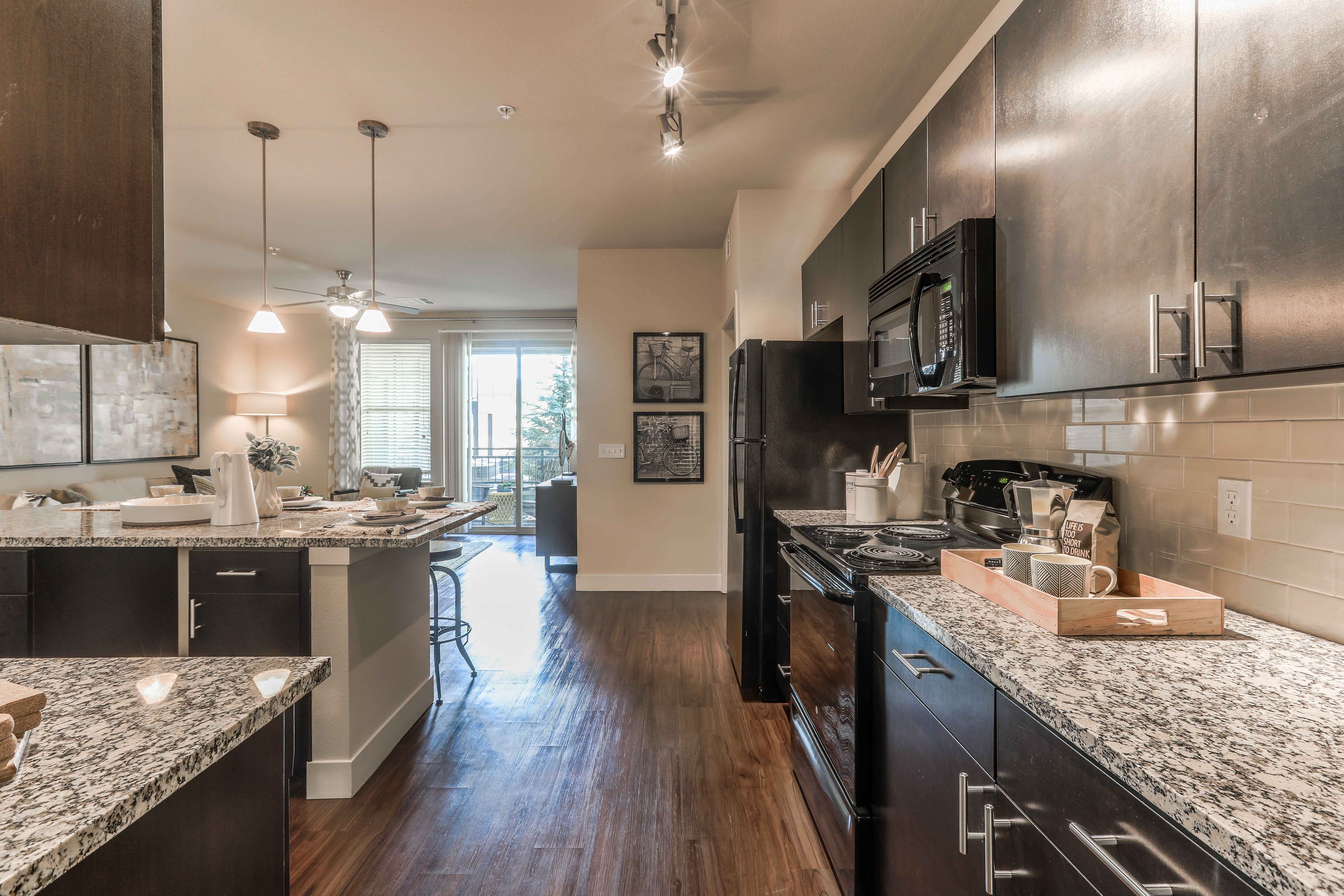 an open kitchen with granite counter tops and stainless steel appliances