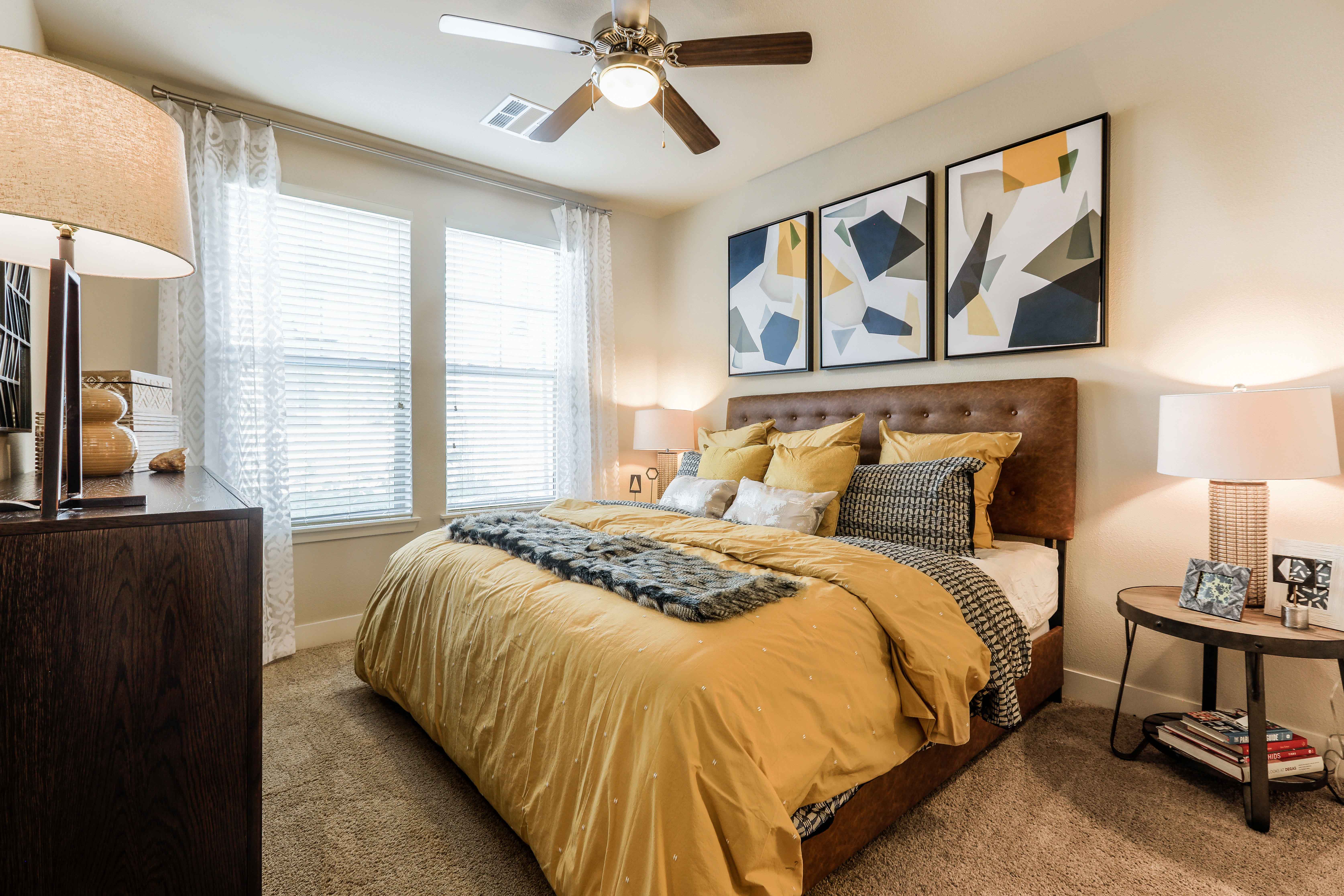 a bedroom with a large bed and a ceiling fan
