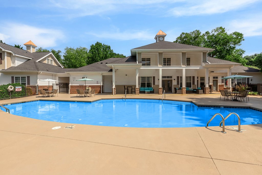 A large house with a pool in front.