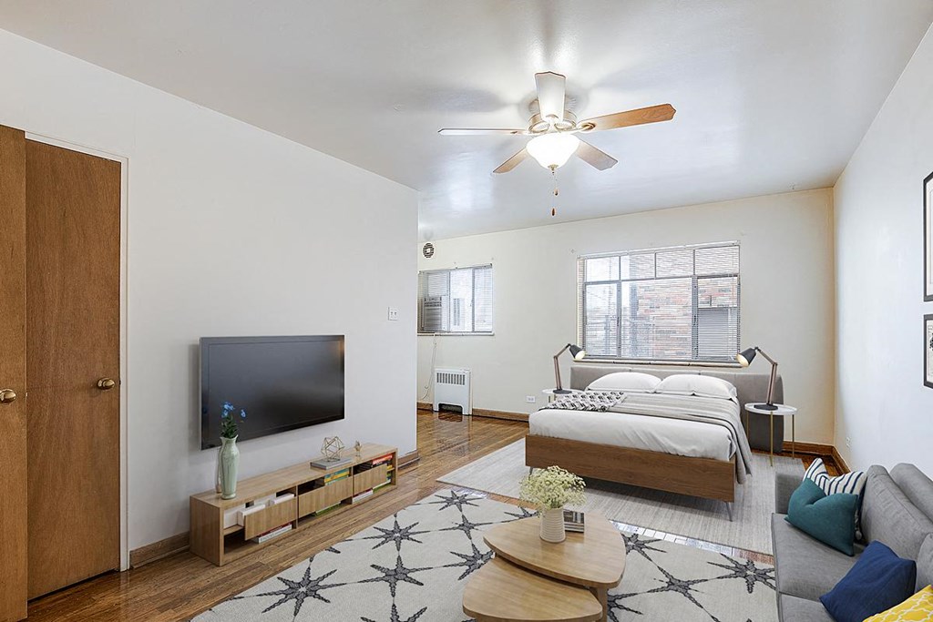 a bedroom with a bed and a ceiling fan