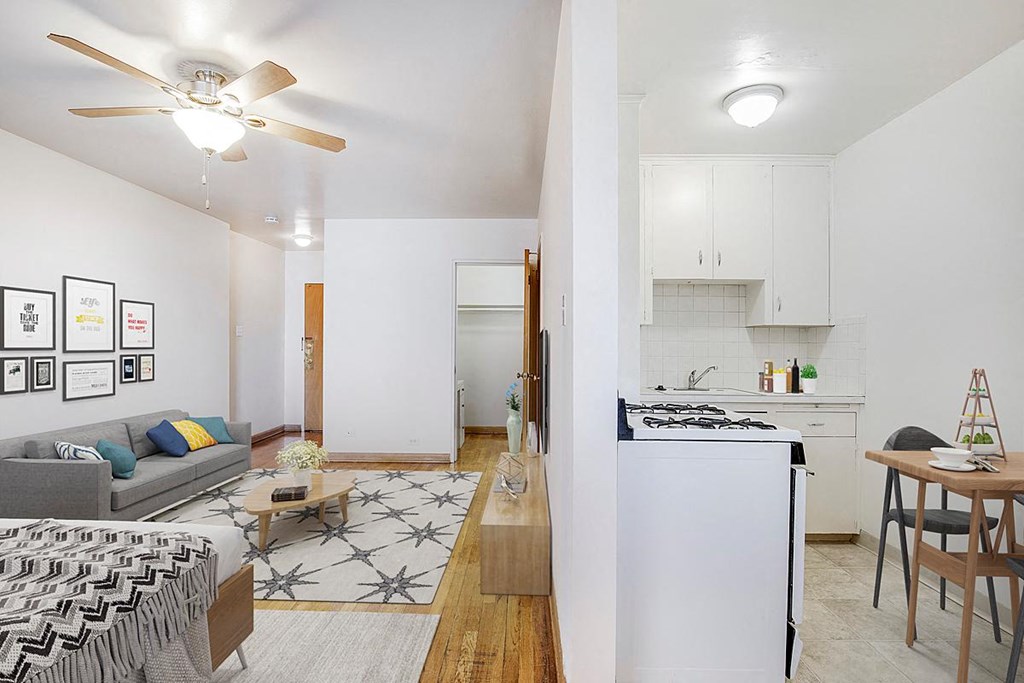 a living area with a kitchen and a living room
