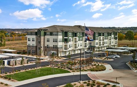Enclave at Cherry Creek Apartments - Building exterior with ample parking