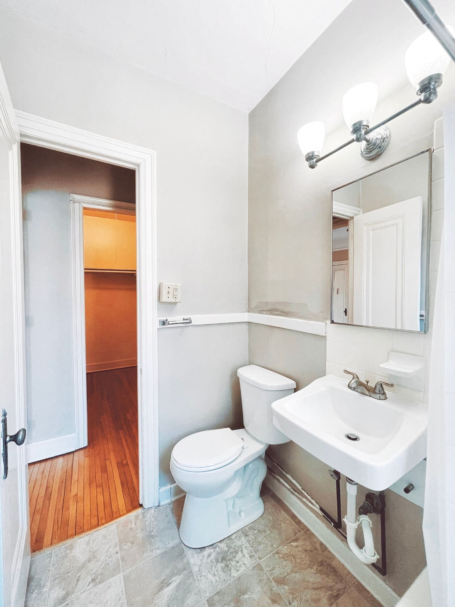 a bathroom with a toilet and a sink and a mirror