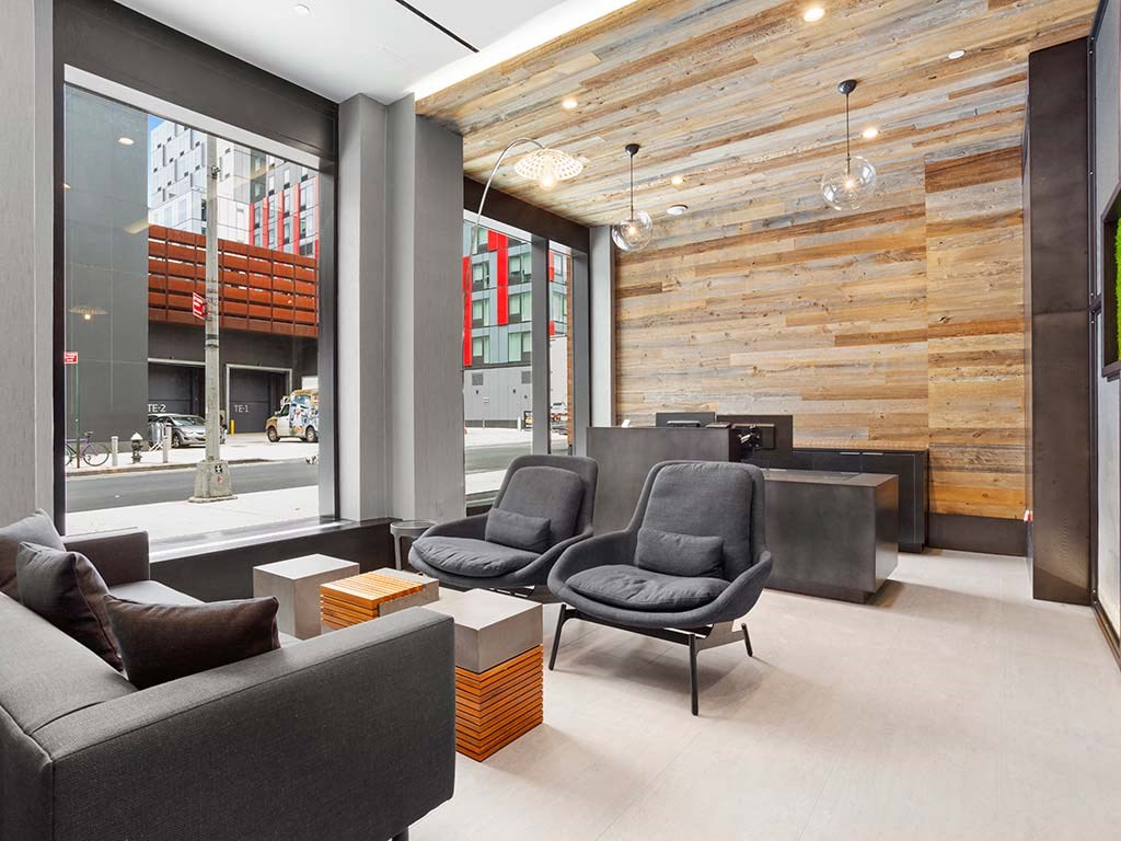 a lobby with chairs and couches and a large window