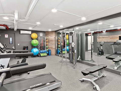 a gym with weights and other equipment on the floor