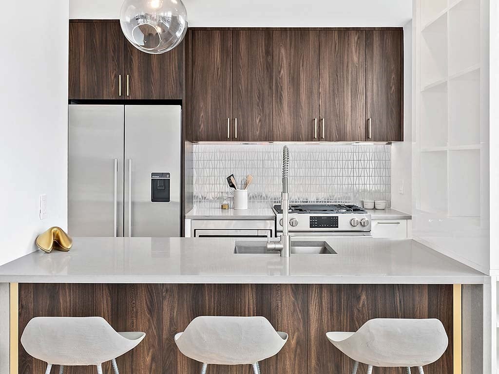 a white kitchen with a stove and a refrigerator