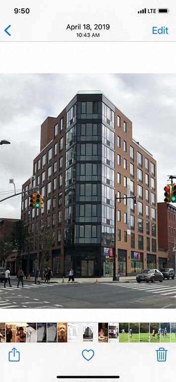 a rendering of a tall building on a city street