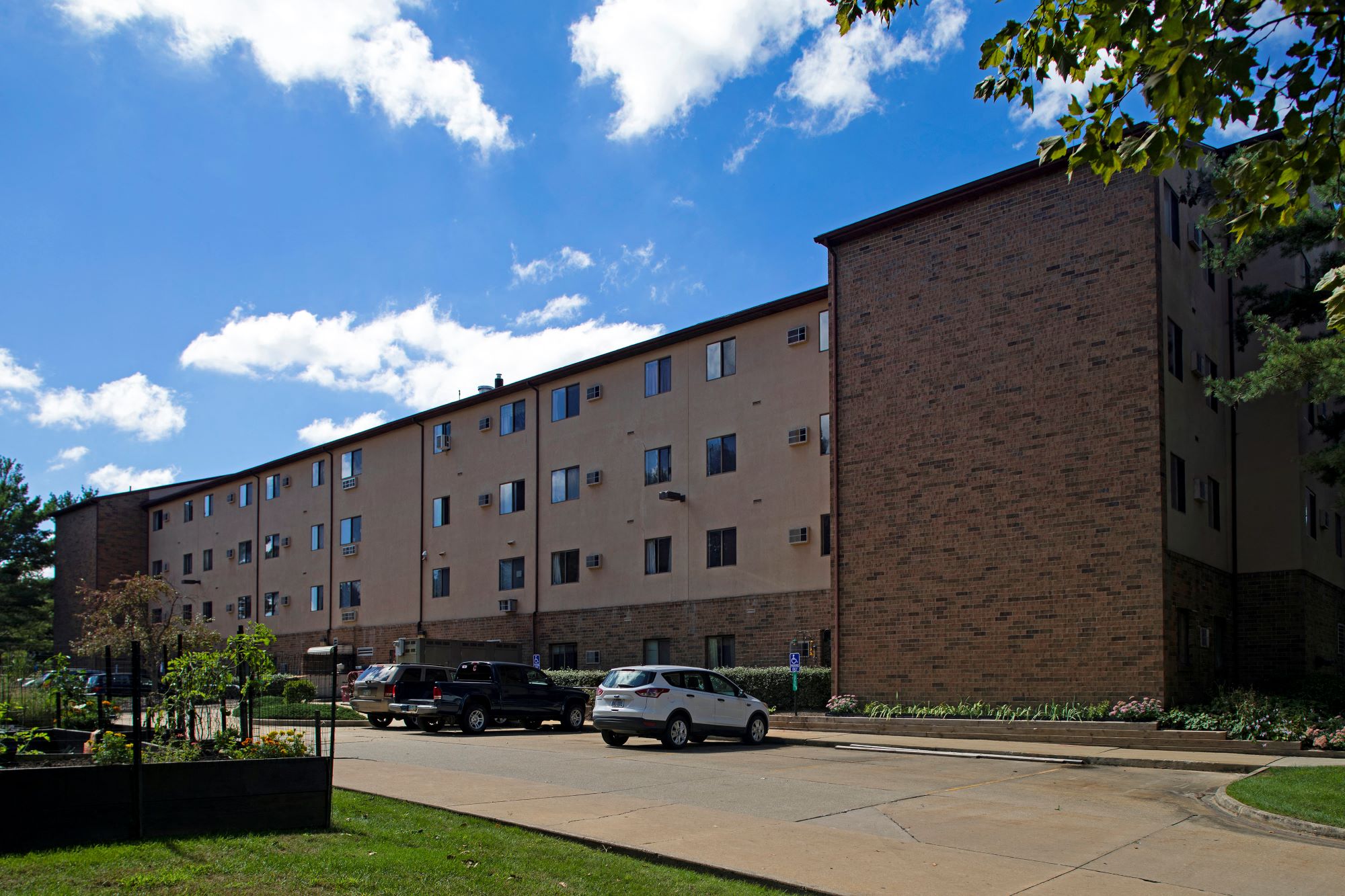 a large brick building with cars parked in front of it