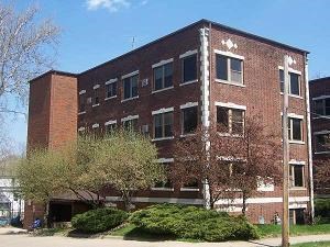 a red brick building with trees in front of it