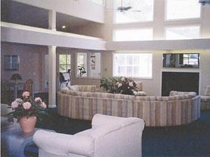 a living room with a large round couch and a fireplace