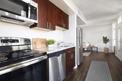 a kitchen with stainless steel appliances and wooden cabinets