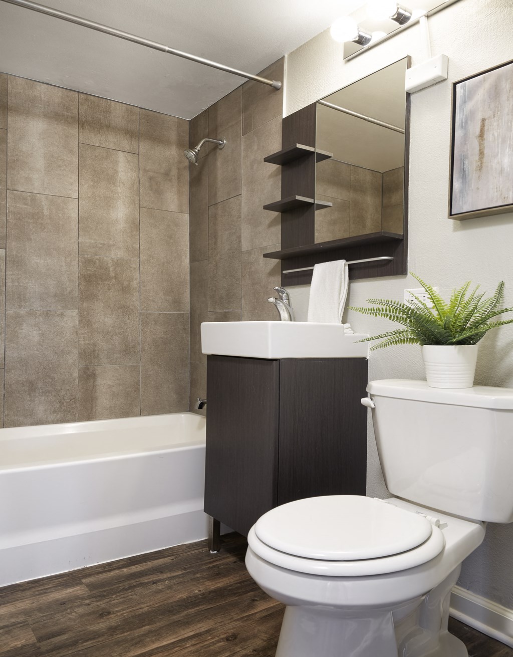 a bathroom with a toilet and a sink and a bath tub