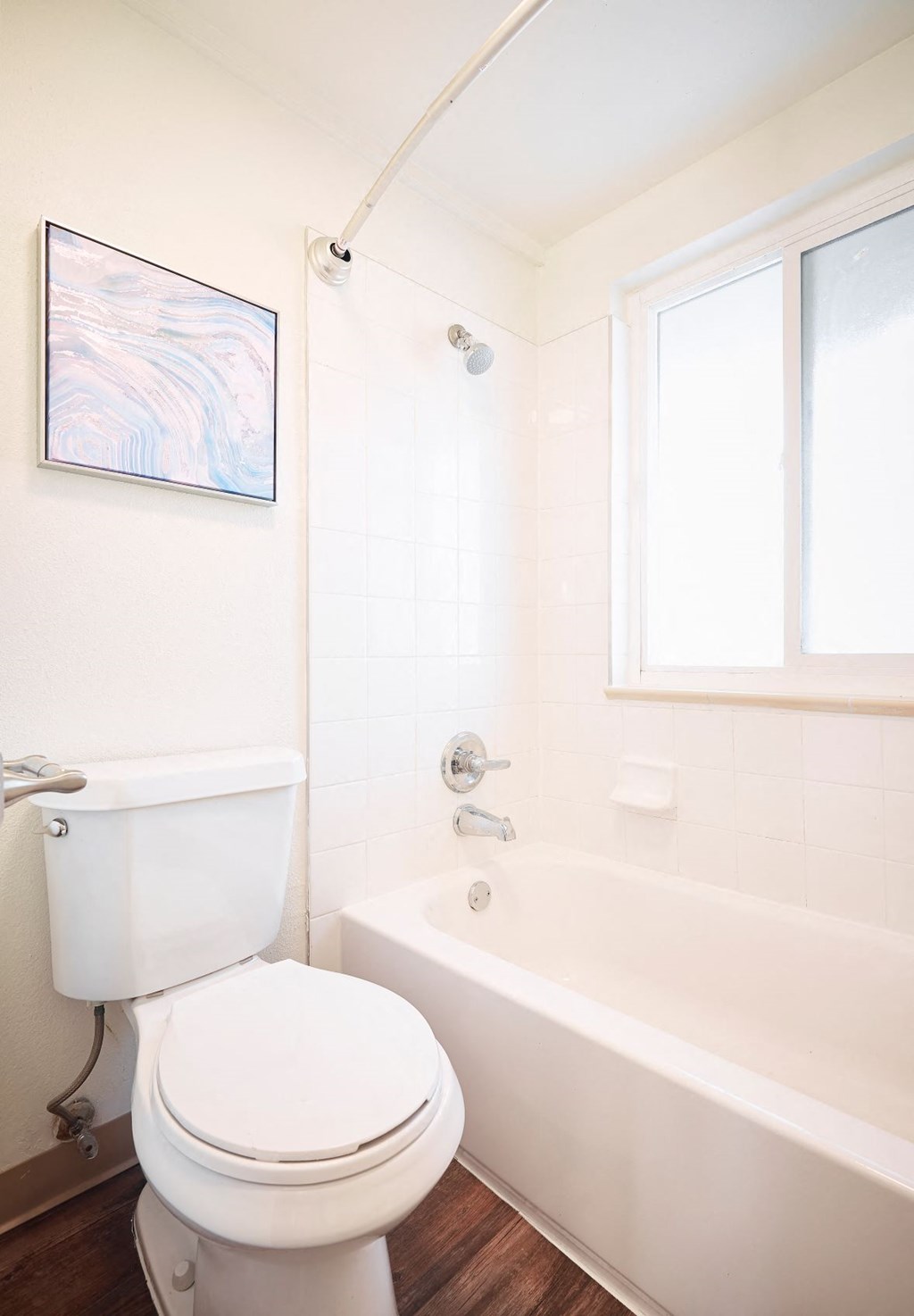 a bathroom with a toilet and a bath tub