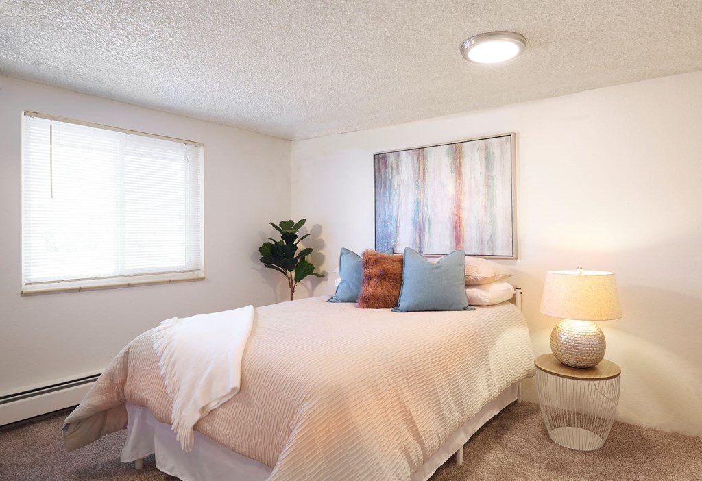 an overview of a bedroom with a bed and a window