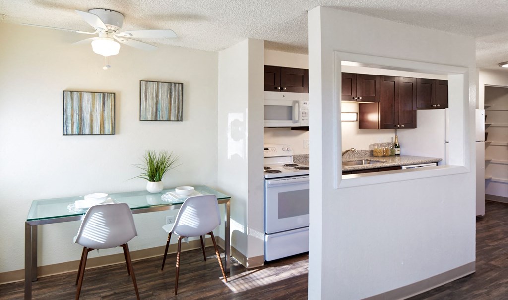 a kitchen and dining room with a table and chairs