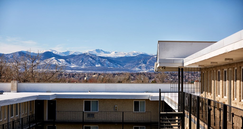 a view of the mountains from the balcony of a building