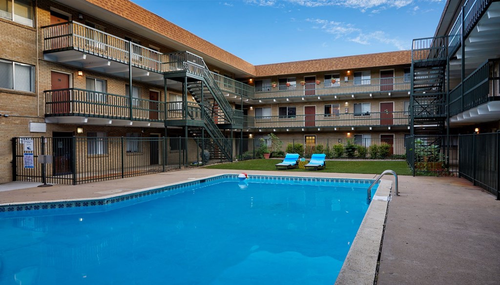 a swimming pool in front of an apartment building
