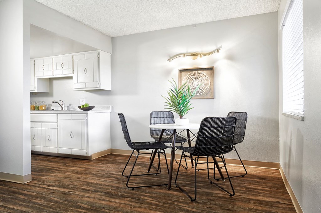 a dining room with a table and chairs and a kitchen