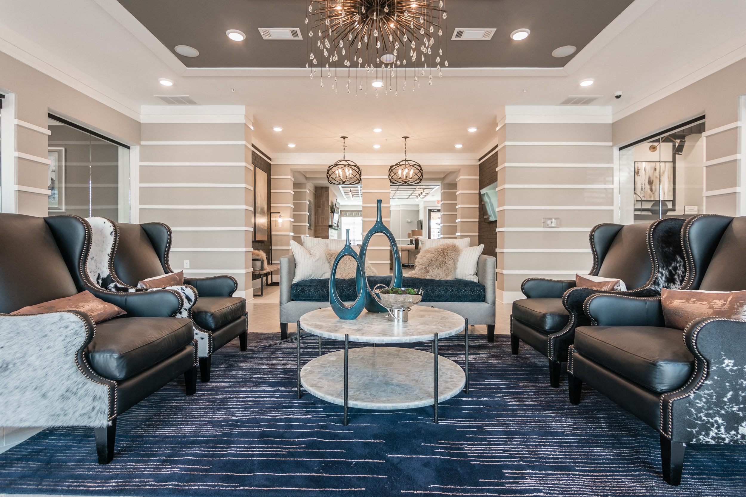 a living room with couches and chairs and a coffee table