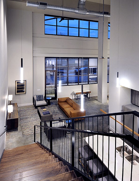 a view of the living room from the second floor of a modern home