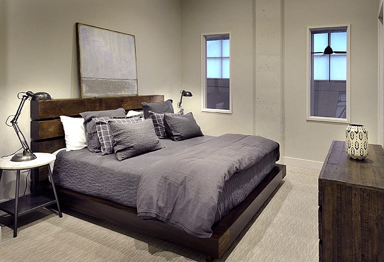 a bedroom with a bed and a dresser and a window