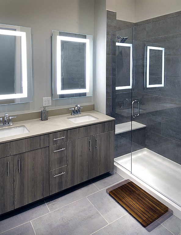 a modern bathroom with two sinks and a shower
