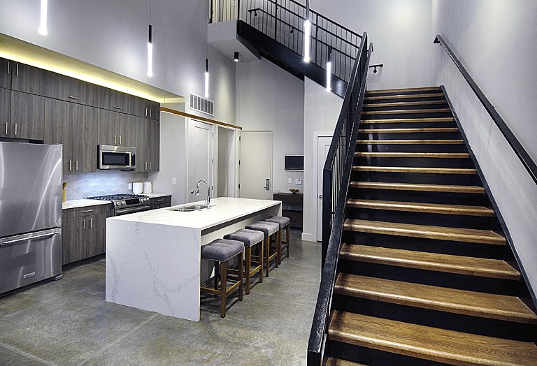 a view of a kitchen and stairs in a house
