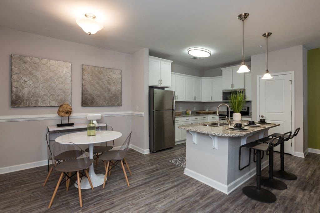 a kitchen and dining room with a table and chairs