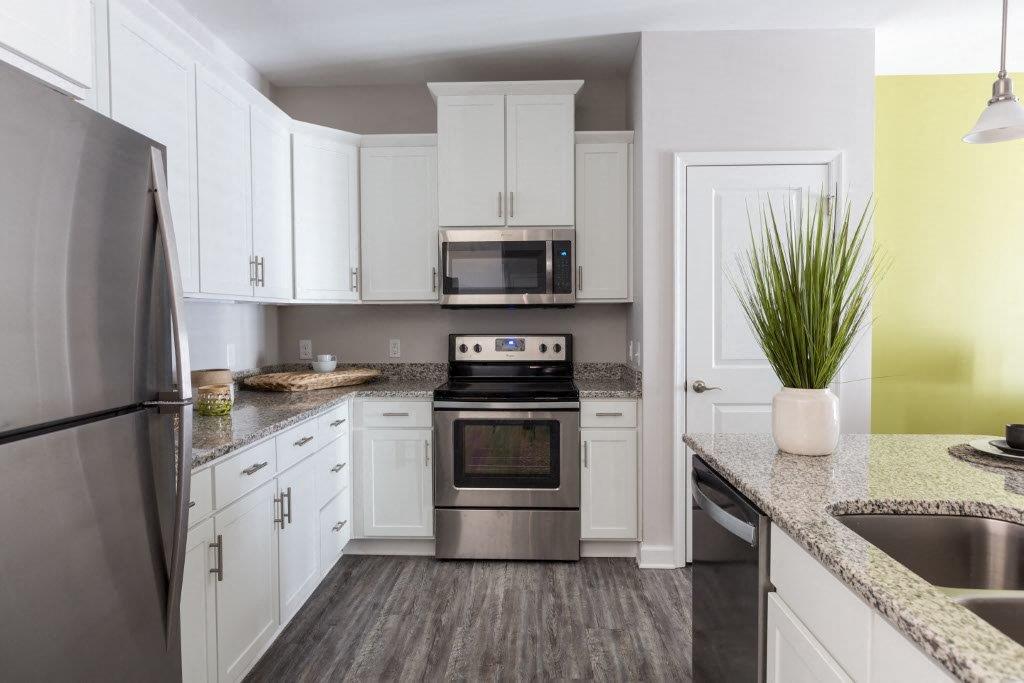 a kitchen with stainless steel appliances and white cabinets