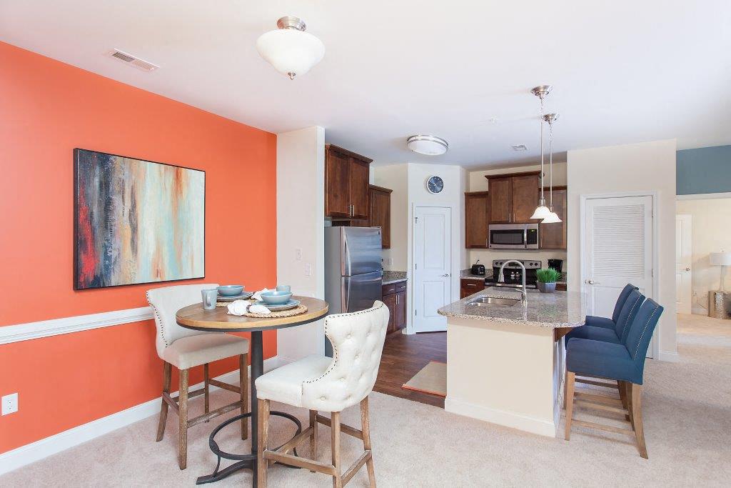 a kitchen and dining room with a table and chairs