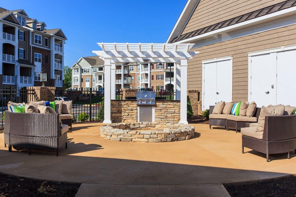 a patio with furniture and a fire pit