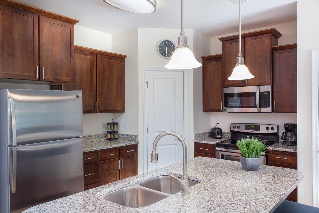 a kitchen with stainless steel appliances and granite counter tops