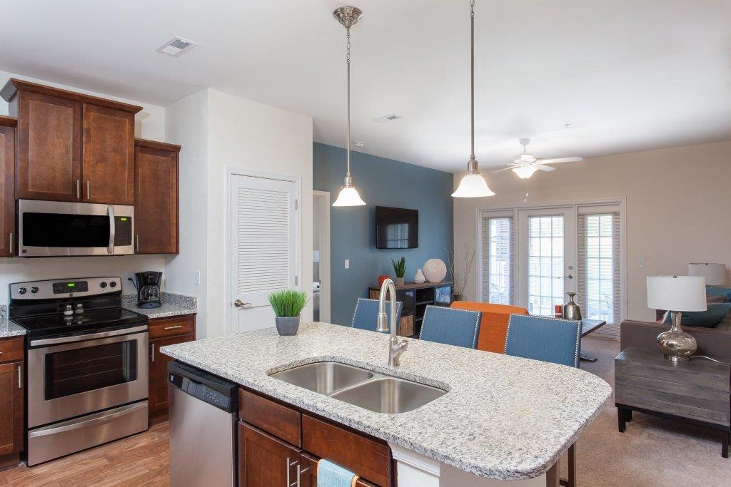 a kitchen and living room with a granite counter top