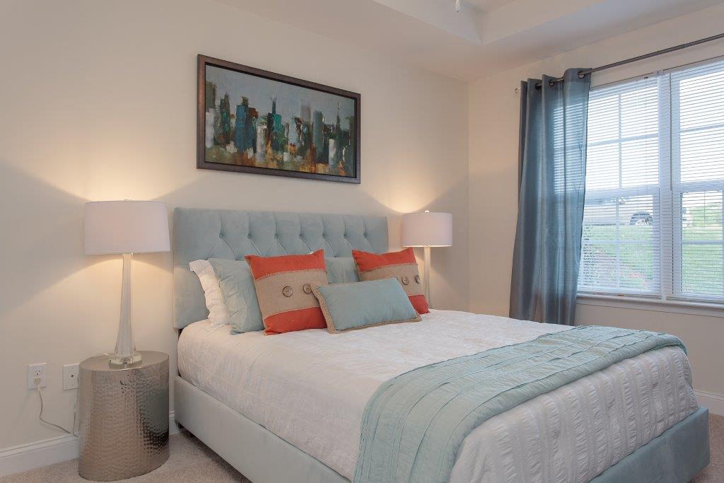 a bedroom with a bed and two lamps