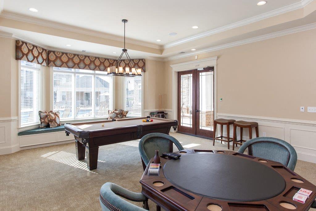 a game room with a pool table and a poker table