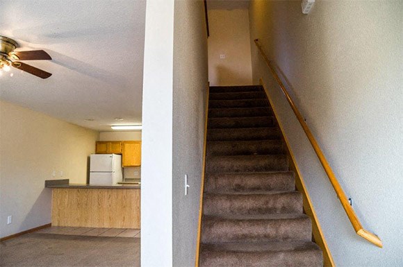 a staircase in a living room and a kitchen