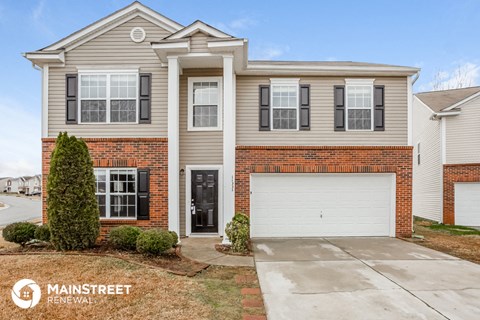 a beige house with a white garage door