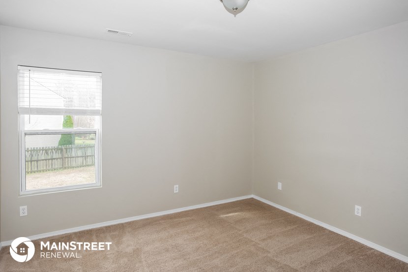 the living room of an empty house with a window
